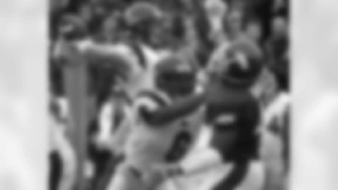 Mississippi running back Toward Sanford (6) blocks Arkansas defensive end Gavin Walls, right, as Mississippi quarterback Eli Manning passes during the first quarter, Saturday, Oct. 26, 2002, in Fayetteville, Ark. (AP Photo/Danny Johnston)