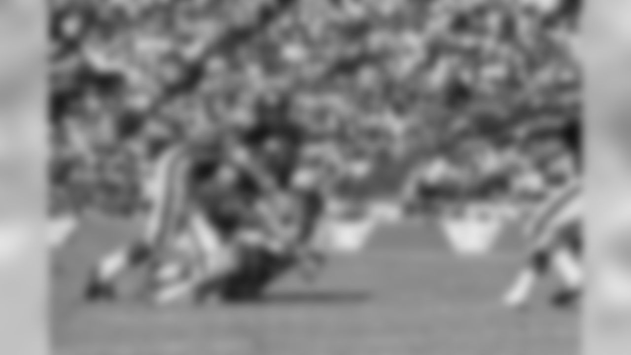 Dallas Cowboy quarterback Don Meredith (17) is tackled after an 8-yard run in the second quarter of Sunday's game at the Cotton Bowl against the New York Giants September 24, 1967. Making the tackle are Giant Linebackers Bill Swain (52) and Vince Costello (57). Meredith led the cowboys to a 38-24 victory over the Giants. (AP Photo)