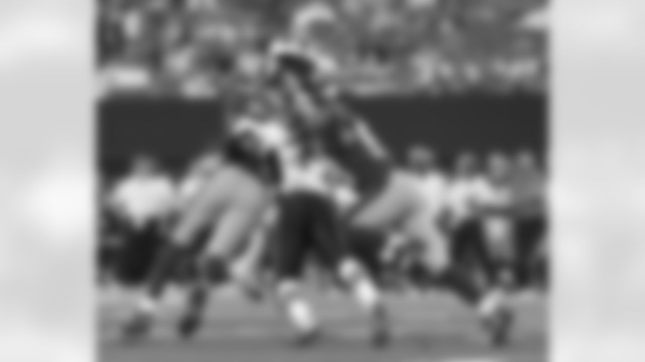 Quarterback Tom Brady (12) of the New England Patriots releases a pass under pressure against the New York Giants at the New Meadowlands Stadium in East Rutherford, New Jersey. The Giants won 20 - 17. (AP Photo / Al Messerschmidt)