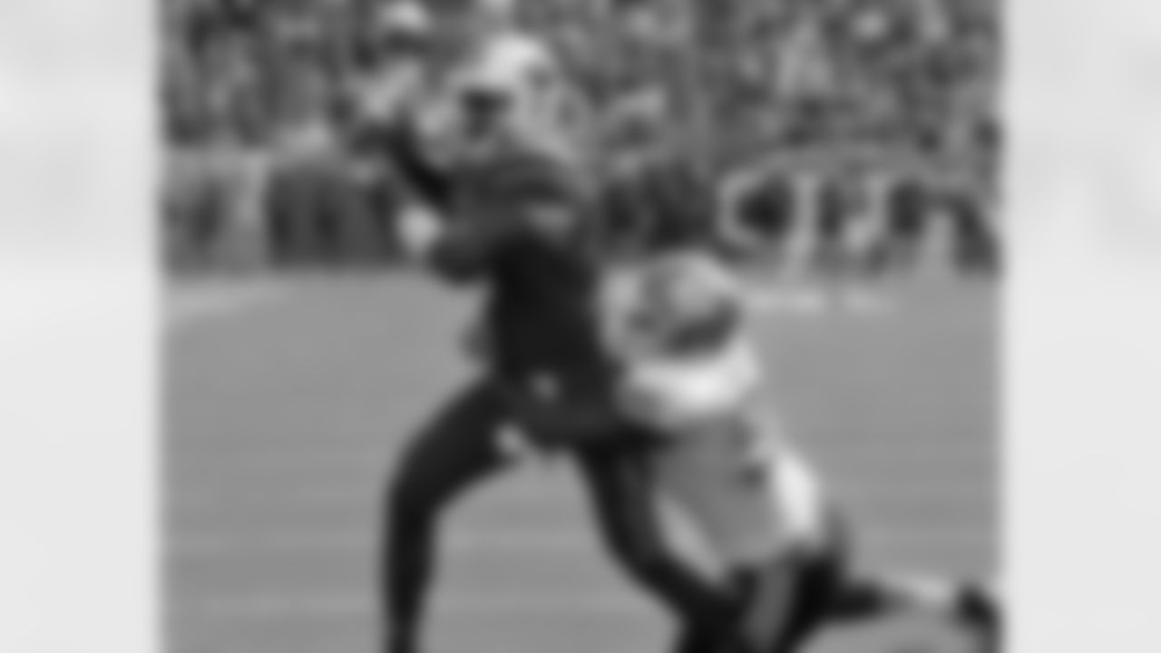Louisville quarterback Teddy Bridgewater tries to pass as he is hit from behind by North Carolina tackler Kareem Martin (5) in a NCAA college football game in Louisville, Ky., Saturday, Sept. 15, 2012. (AP Photo/Garry Jones)