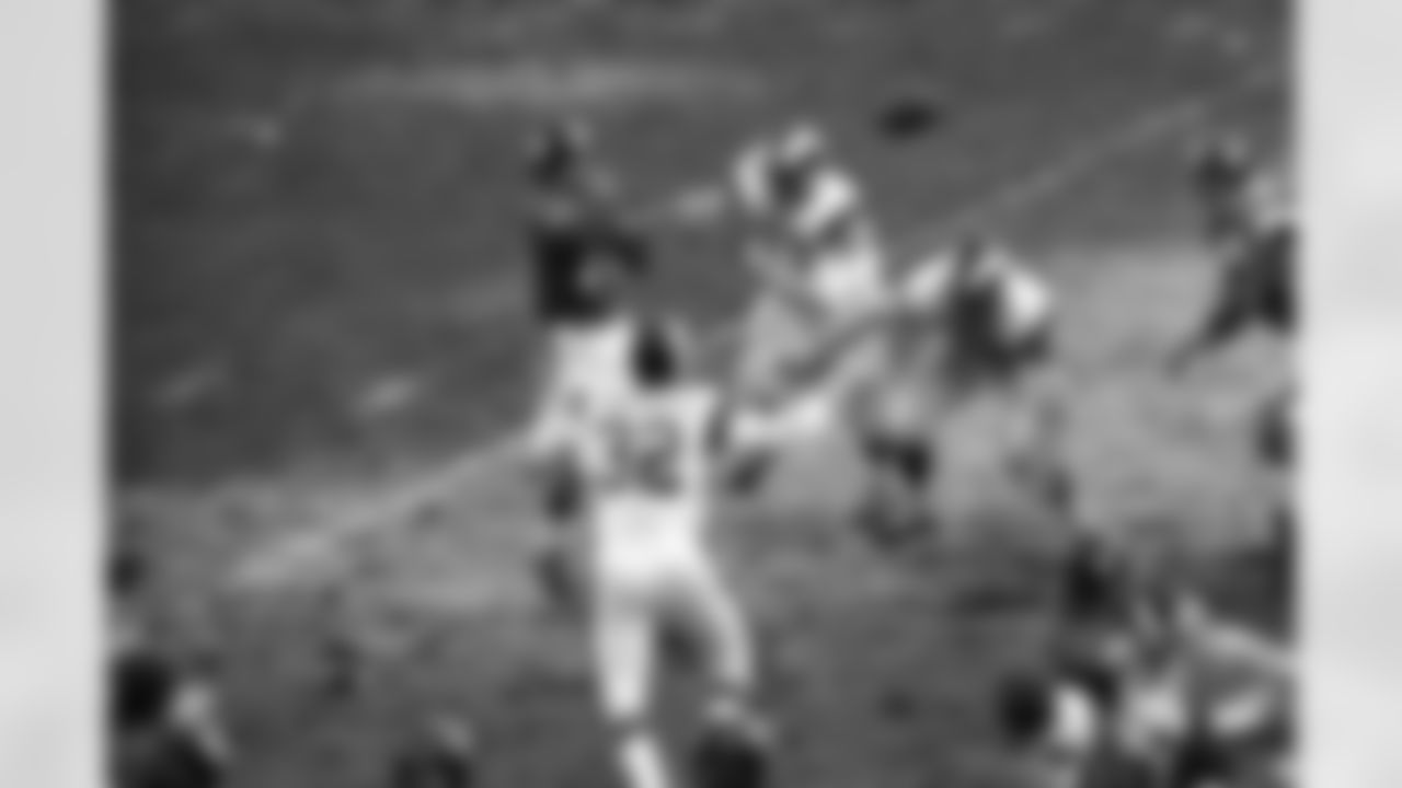 Fran Tarkenton, the Giants quarterback, gets off a pass, incomplete, in the face of a furious charge by a trio of Los Angeles Rams defenders in the second period at Yankee Stadium, Dec. 20, 1970, New York. Closing in on Tarkenton are Jack Pardee (32), Coy Bacon (79) and Diron Talbert. (AP Photo)