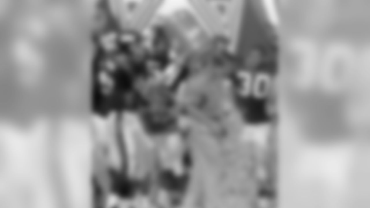New York Giants head coach Jim Fassel, who turned 48 years-old, has a bucket of Gatorade dumped on him by quarterback Dave Brown in celebration of their 31-17 win over the Philadelphia Eagles at Giants Stadium in East Rutherford N.J. on Sunday, August 31, 1997. Giants Corey Miller (57) and Charles Way (30) watch. (AP Photo/Dan Hulshizer)