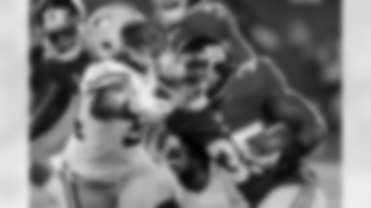 New York Giants' Andre Brown (35) rushes past Green Bay Packers' Dezman Moses (54) during the first half of an NFL football game