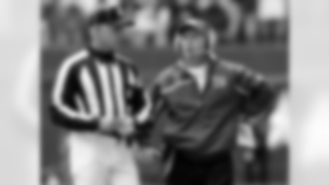 New York Giants head coach Tom Coughlin, right, talks with an official as he calls for a review of a play against the Dallas Cowboys in the second quarter of an NFC divisional playoff football game, Sunday, Jan. 13, 2008, in Irving, Texas. (AP Photo/Tony Gutierrez)