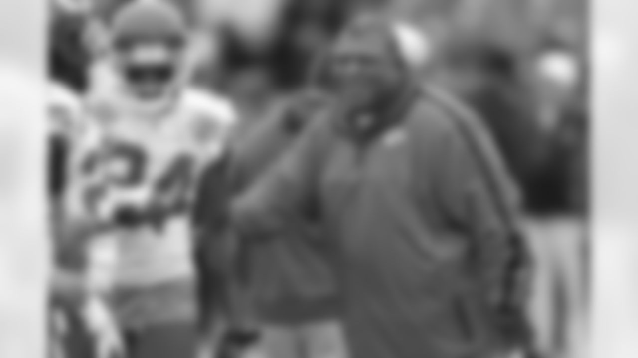 Kansas City Chiefs head coach Romeo Crennel, right, laughs with cornerback Brandon Flowers (24) before an NFL football game against the Oakland Raiders in Oakland, Calif., Sunday, Dec. 16, 2012. (AP Photo/Ben Margot)