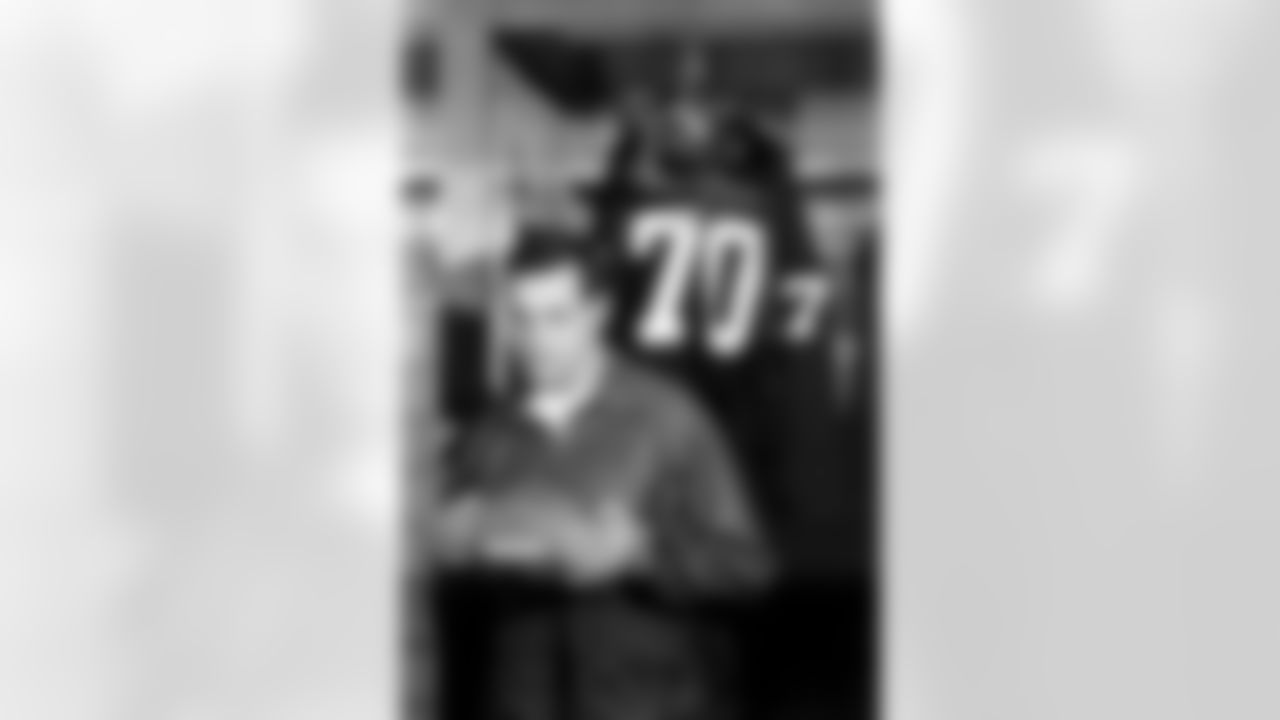 Washington Redskins defensive captain Sam Huff poses in front of his jersey in the locker room in Washington, D.C., Dec. 12, 1967. Huff announced he will retire Dec. 17, after his team's final game of the year. Huff, 33, one of professional football's all-time linebackers and five times an All-National Football League selection, has spent the past four years with Washington following an eight year stint with the New York Giants. (AP Photo)