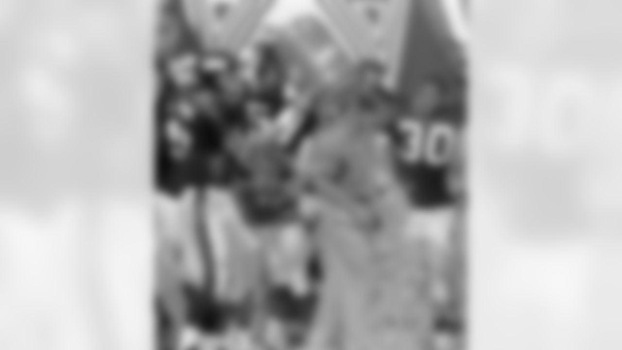 New York Giants head coach Jim Fassel, who turned 48 years-old, has a bucket of Gatorade dumped on him by quarterback Dave Brown in celebration of their 31-17 win over the Philadelphia Eagles at Giants Stadium in East Rutherford N.J. on Sunday, August 31, 1997. Giants Corey Miller (57) and Charles Way (30) watch. (AP Photo/Dan Hulshizer)