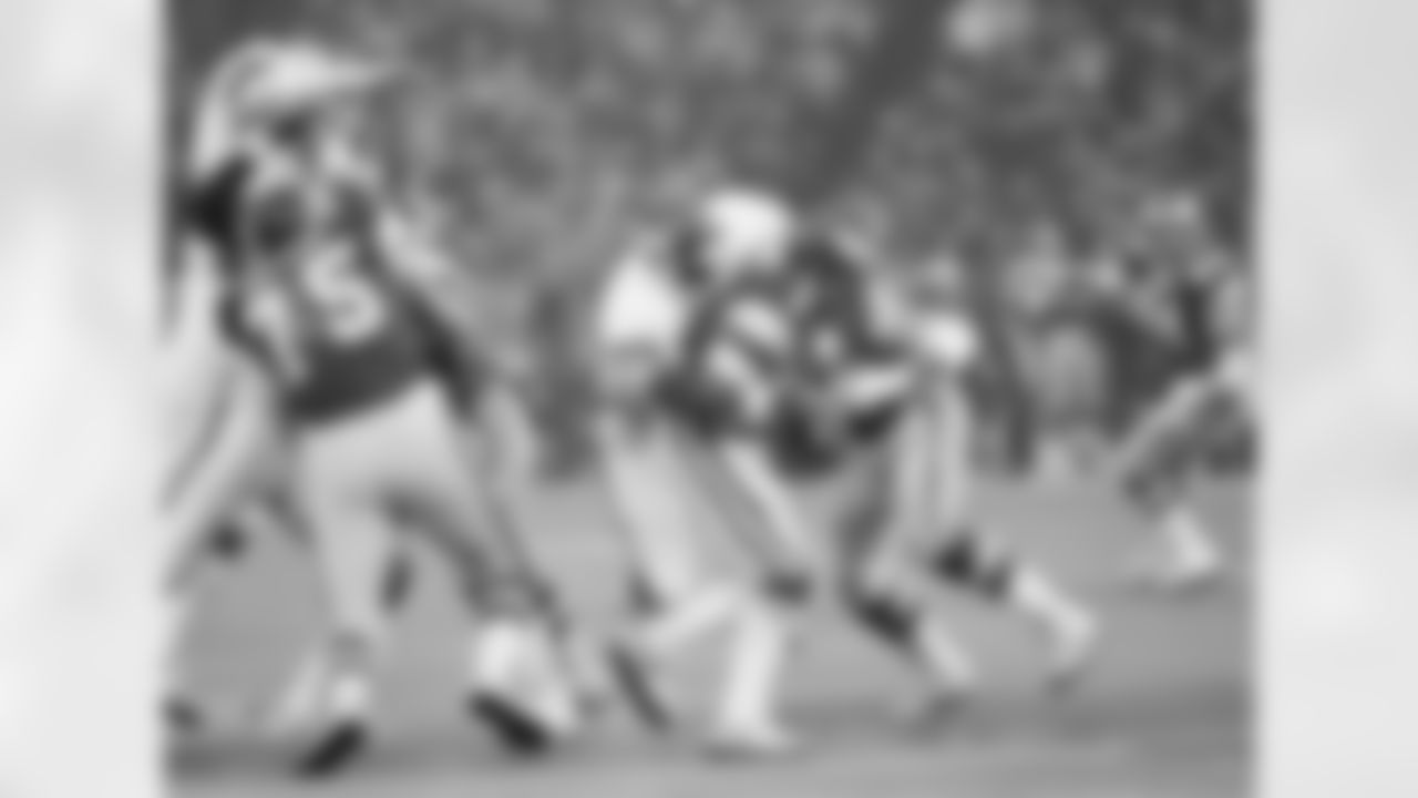 Eagles quarterback Ron Jaworski drops the football as he is hit by New York Giants George Martin (75) in wild card playoff game, Sunday, Dec. 27, 1981, Philadelphia, Pa. The fumble was not allowed, but Jaworski lost nine yards on the sack play. The rest of the players are unidentified. (AP Photo)