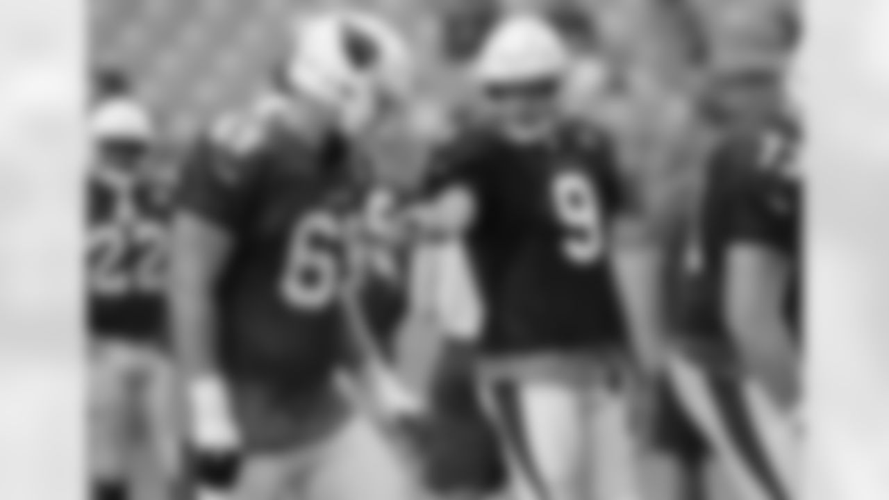 Arizona Cardinals quarterback Sam Bradford (9) points to offensive tackle Will Holden (69) during an NFL football practice, Thursday, Aug. 2, 2018, in Glendale, Ariz. (AP Photo/Ross D. Franklin)