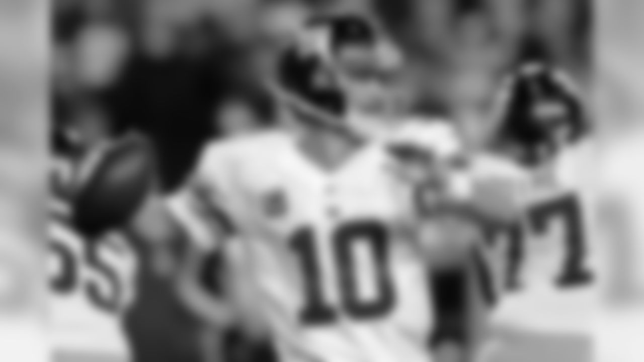 New York Giants quarterback Eli Manning (10) passes the ball during the first half of an NFL football game against the Washington Redskins in Landover, Md., Monday, Dec. 3, 2012. (AP Photo/Nick Wass)
