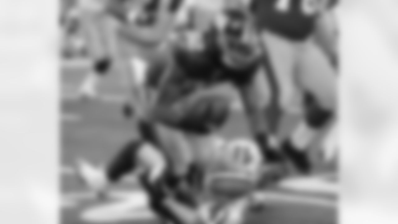 WR Mario Manningham runs over a Cowboys defender for a first down.