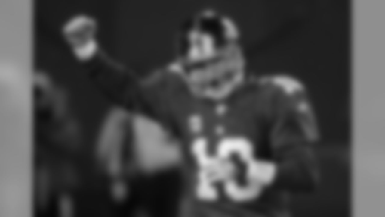 FILE -- This is a Dec. 21, 2008, file photo showing New York Giants quarterback Eli Manning celebrating after the Giants scored a touchdown to pull within two points of the Carolina Panthers, 28-26, late in their NFL football game, at Giants Stadium in East Rutherford, N.J. The Giants tied the game with a two point conversion and won in overtime, 34-28. (AP Photo/Henny Ray Abrams, File)