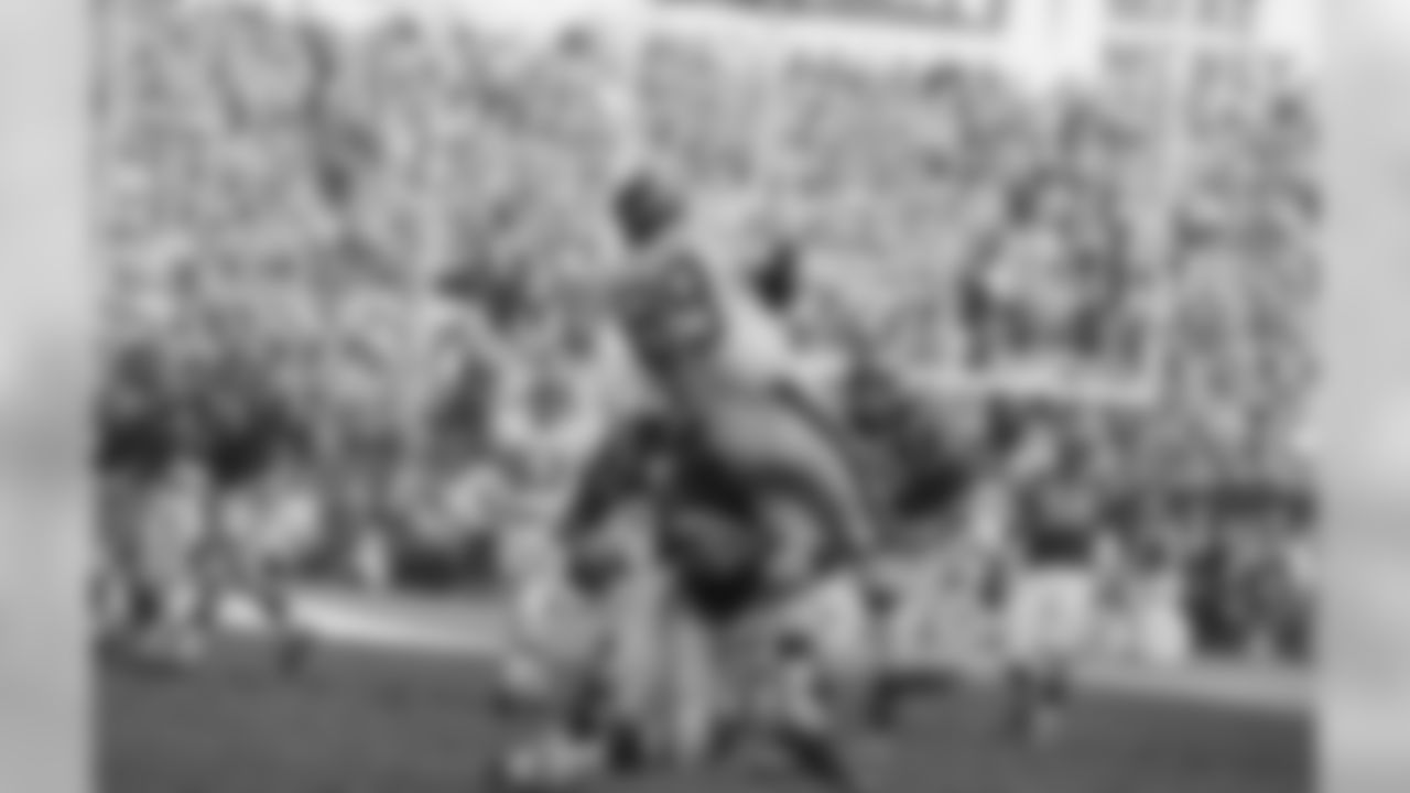 New York Giants end Bob Crespino (89) takes in a pass from quarterback Fran Tarkenton and is brought down by Nate Ramsey of the Philadelphia Eagles in the national football league game in New York on Nov. 26, 1967. Dave Lloyd of the Eagles (partly obscured by Ramsey) was charged with a foul and Philadelphia was penalized 15 yards. The giants won 44-7. (AP Photo/ Harry Harris)