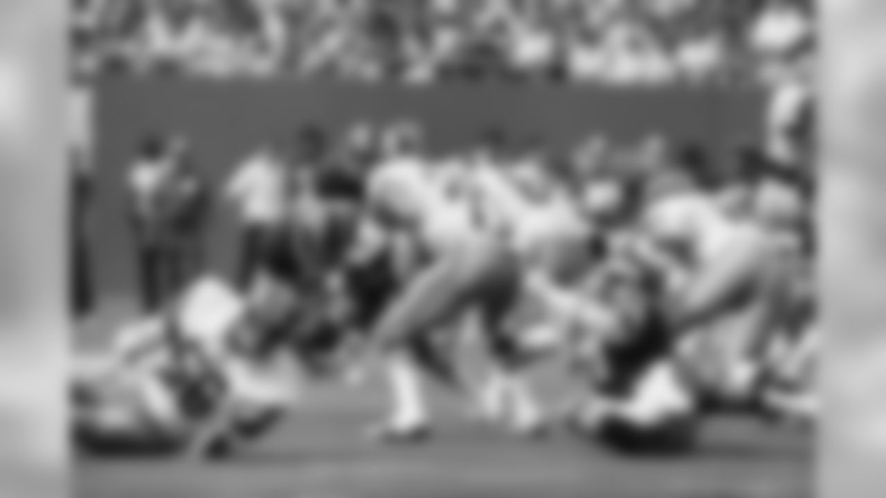 As Washington Redskins runningback Mike Thomas watches, Harry Carson of the New York Giants scoops up Thomas? fumble in the fourth quarter at Giants Stadium, Sept. 18, 1977. The Giants' Troy Archer, right, holds back Thomas. The Giants were then able to run down the clock and kick a field goal to win the game 20-17. (AP Photo/Ray Stubblebine)