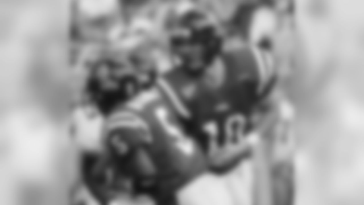 Mississippi quarterback Eli Manning (10) hands off to running back Ronald McClendon (5) for a third-quarter 3-yard run against Arkansas State, Saturday, Oct. 12, 2002, in Oxford, Miss. Mississippi defeated Arkansas State, 52-17, as Manning tied the school record for career touchdown passes with 43, sharing the mark with Romaro Miller. However, Manning was more pleased with the way the Rebels balanced their attack with 188 yards rushing. (AP Photo/Rogelio Solis)