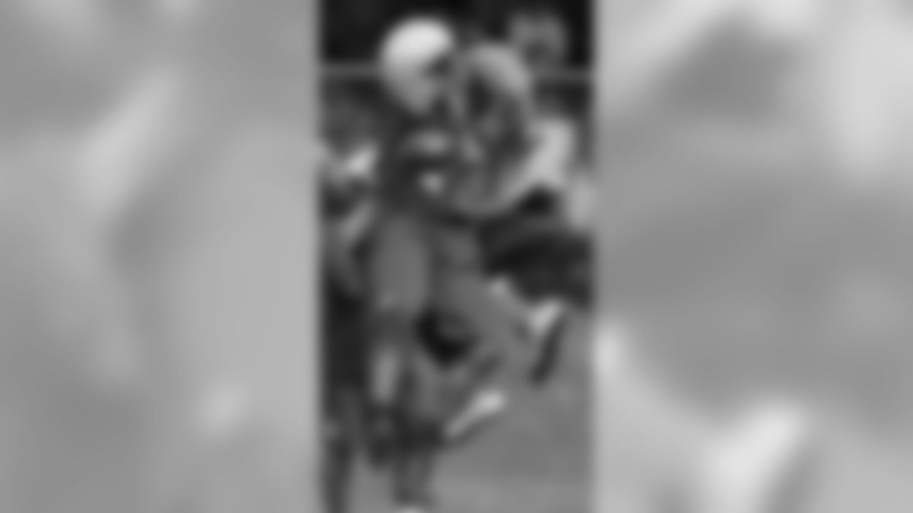 New York Giants defensive end Osi Umenyiora (72), left, and Jason Pierre-Paul celebrate after Umenyiora caught a pass during a defensive drill in workout at the New York Giants NFL football training camp in Albany, N.Y.