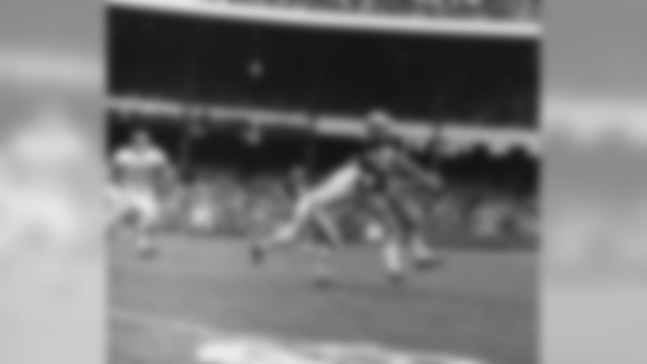 Jim Taylor of the New Orleans Saints reaches for the ball, thrown by quarterback Gary Cuozzo, as it falls incomplete in the third quarter of the Saints-Giants National Football League game in New York on Oct. 8, 1967. Defensive back Wendell Harris of the Giants, left, is set for the tackle. The Giants won 27-21. (AP Photo)