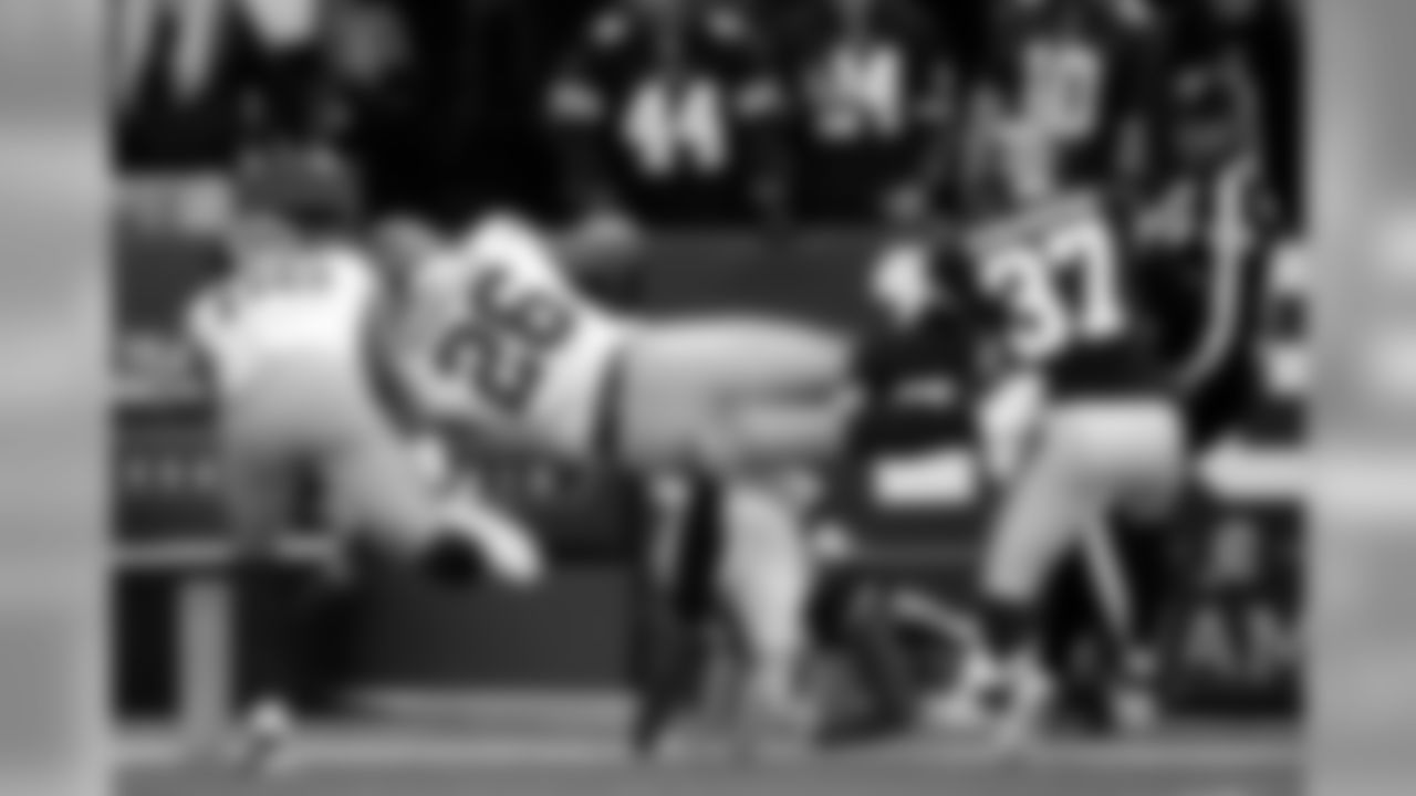 New York Giants running back Saquon Barkley (26) dives over Washington Redskins cornerback Aaron Colvin for a touchdown ona long run during the first half of an NFL football game, Sunday, Dec. 22, 2019, in Landover, Md. (AP Photo/Alex Brandon)