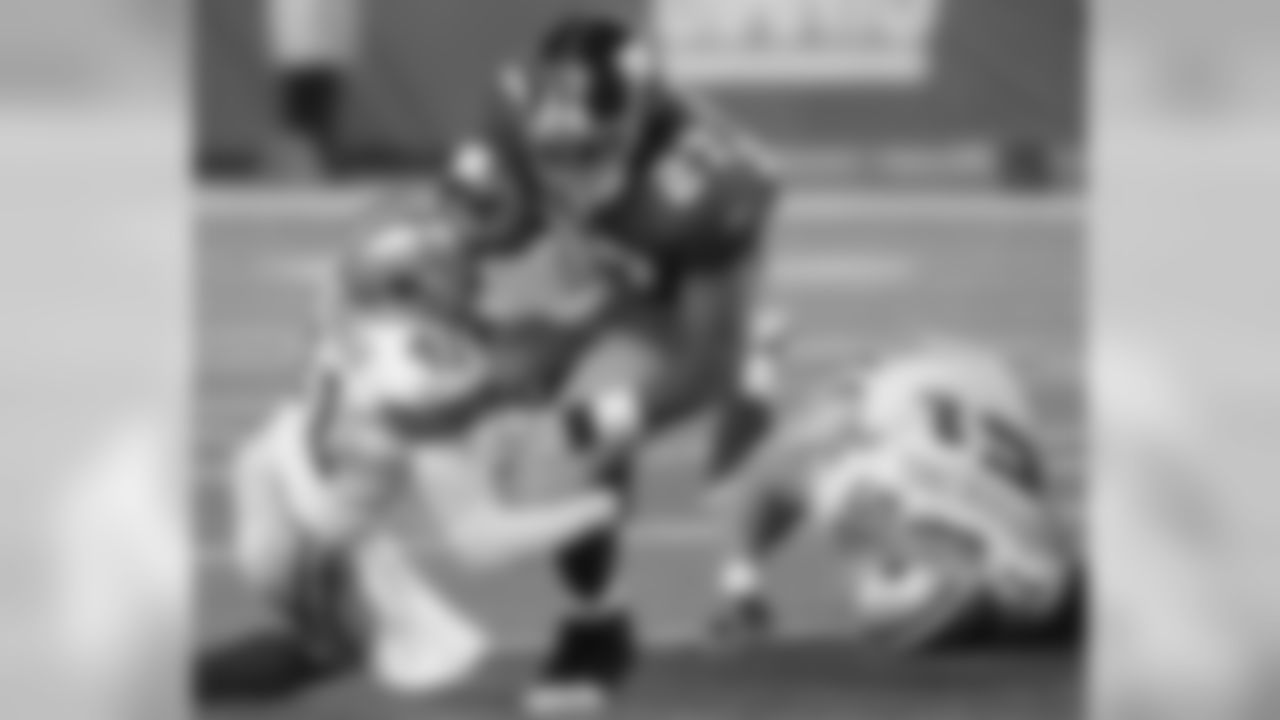 RB Brandon Jacobs runs over a couple of Cowboys defenders for a first down.