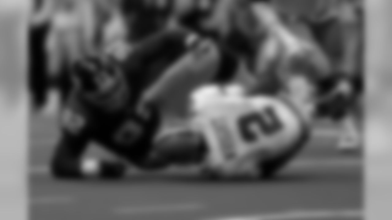 Dallas Cowboys quarterback Anthony Wright (2) hits the ground after being sacked by New York Giants defensive end Michael Strahan in the fourth quarater Sunday, Dec. 17, 2000 in Irving, Texas. (AP Photo/Donna McWilliam)
