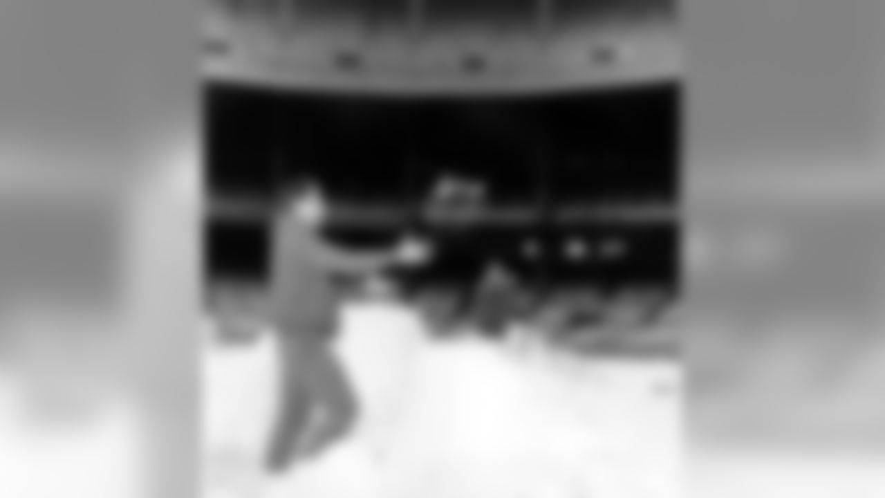New York Giants quarterback Y.A. Tittle passes a snowball to teammate and halfback Frank Gifford, left, as they play around on a mound of snow at New York's Yankee Stadium on Dec. 24, 1963. The Giants play the Chicago Bears on Dec. 29 for the National Football League Championship. (AP Photo)