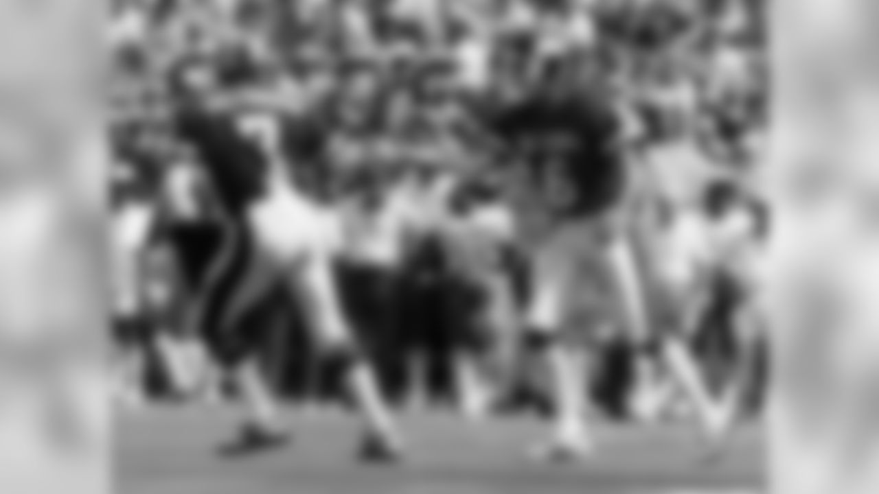 NFC quarterback Joe Theismann (7) of the Washington Redskins congratulates Giants place kicker Ali Haji-Sheikh (6) after kicking a 23-yard field goal during the NFC's 45-3 victory over the AFC in the 1984 NFL Pro Bowl played on January 29, 1984 at Aloha S