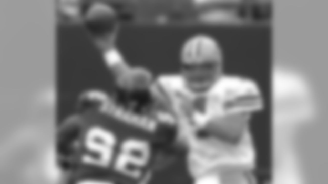 Green Bay Packers quarterback Brett Favre, right, passes the ball as he is pressured by New York Giants defensive end Michael Strahan (92) during first quarter NFL football Sunday, Sept. 16, 2007 at Giants Stadium in East Rutherford, N.J. Favre completed 29-of-38 passes for 286 yards and three touchdowns as the Packers beat the Giants 35-13. The victory allowed Favre to become the winningest quarterback in NFL history.(AP Photo/Bill Kostroun)