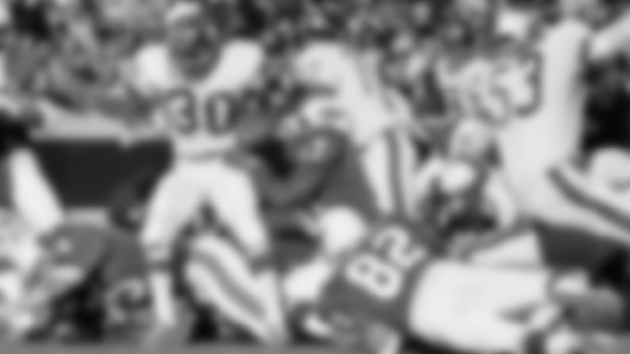 Ron Johnson (30) of the New York Giants is halted in his tracks by Don Parish of the St. Louis Cardinals after Johnson made a gain of five yards in first quarter action on Sunday, Dec. 13, 1970 at St. Louis. (AP Photo)