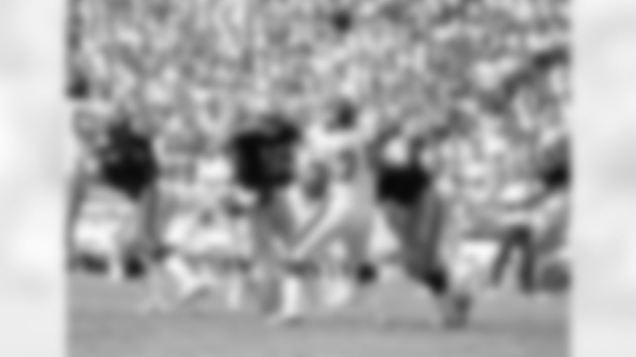 Los Angeles Raider Jim Plunkett (16), the oldest quarterback in the NFL, gets popped from behind by New York Giants' Andy Headen, forcing an early turnover during first-half action at the Coliseum in Los Angeles, Sept. 21, 1986. Also in on the play are Giants' Jerome Sally (78), and Raiders' Mickey Marvin. (AP Photo/Bob Galbraith)