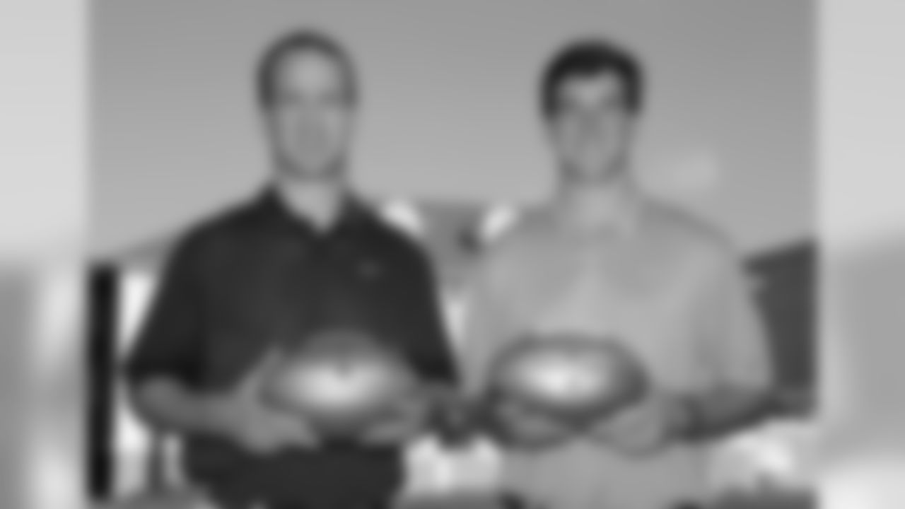 IMAGE DISTRIBUTED FOR NATIONAL FOOTBALL LEAGUE - In this photo released by the NFL, Denver Broncos quarterback Peyton Manning, left, and New York Giants quarterback Eli Manning pose for a photo during a visit to Isidore Newman School in New Orleans on Thursday, July 9, 2015. (Jonathan Bachman/AP Images for National Football League)