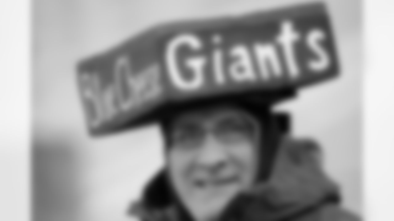 New York Giants fan Kevin Bock shows off his blue cheese hat before an NFL divisional playoff football between the Green Bay Packers and the New York Giants Sunday, Jan. 15, 2012, in Green Bay, Wis. (AP Photo/Mike Roemer)