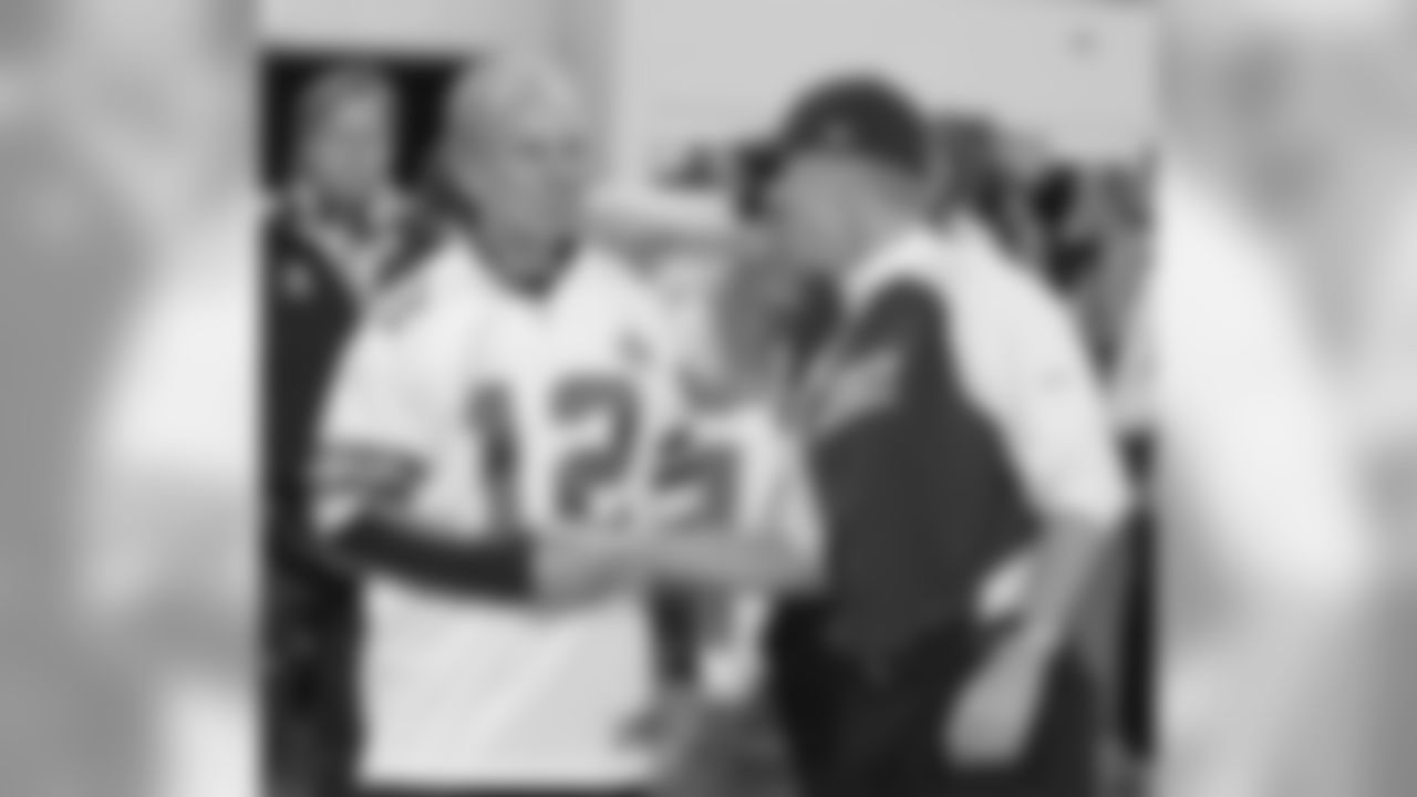 Dallas Cowboys honorary captain Roger Staubach (12) talks with coach Jason Garrett before an NFL football game against the Philadelphia Eagles, Sunday, December 12, 2010 at Cowboys Stadium in Arlington, Texas. The Eagles won the game, 30-27. (AP Photo/James D Smith)