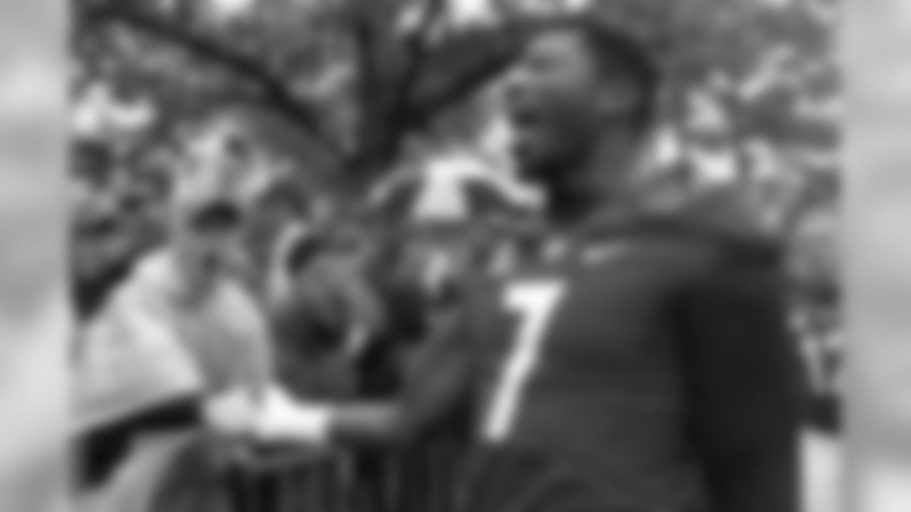 Georgia linebacker Lorenzo Carter (7) slaps hand with a fan during the 'Dog Walk" as he and the Bulldogs arrive for an NCAA college football game against Alabama, Saturday, Oct. 3, 2015, in Athens, Ga. (AP Photo/Brett Davis)