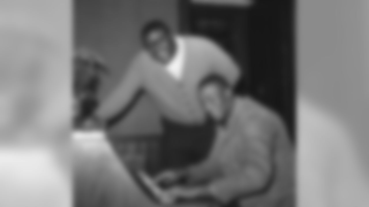New York Giants tackle Roosevelt Grier, who has made several popular recordings, sings as his teammate Erich Barnes plays the piano at Bear Mountain Inn, Bear Mountain, New York on Dec. 26, 1962. The Giants have been traveling from Bear Mountain to nearby West Point for indoor drills in preparation for the National Football League title game with the Green Bay Packers at New York's Yankee Stadium on December 30. (AP Photo)