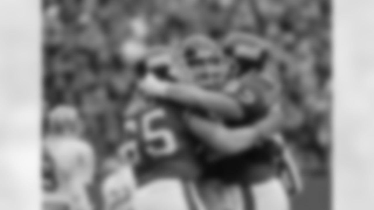 New York Giants player Bart Oates (65), Conrad Goode (62) and an unidentified teammate, hug after the Giants pulled ahead of the San Francisco 49ers during the third quarter, Sunday, Dec. 29, 1985 at Giant Stadium in East Rutherford, N.J. The Giants advanced in the NFL playoffs by beating San Francisco 49ers 17--3 and will play the Chicago Bears Jan. 5th. (AP Photo)