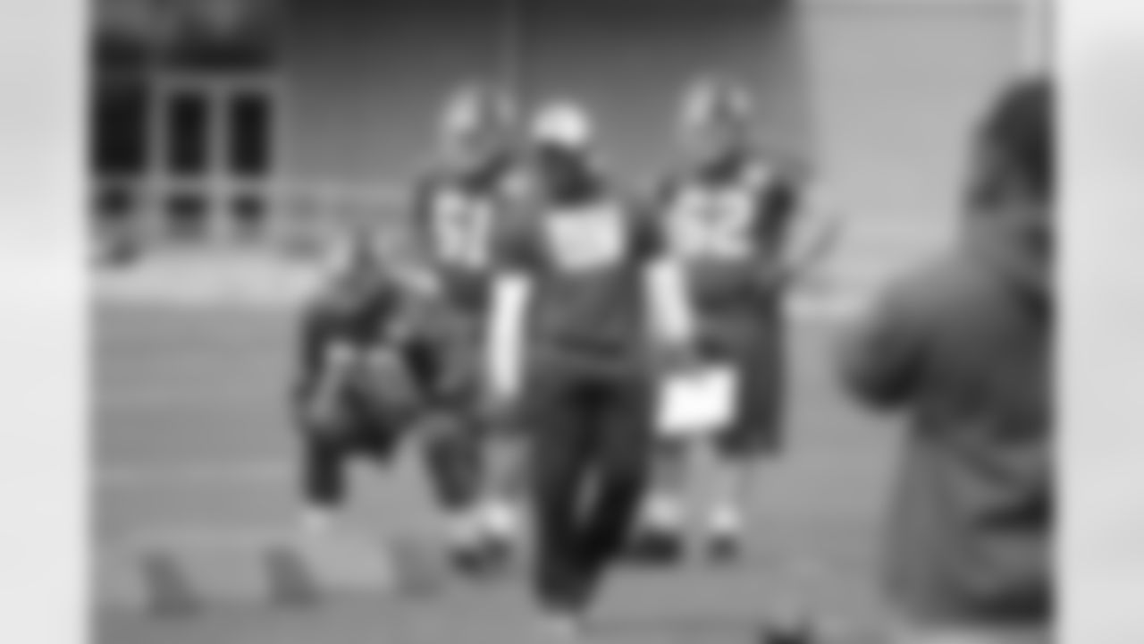 Defensive coordinator Perry Fewell patrols the field at rookie minicamp.