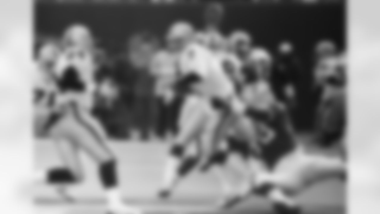 Los Angeles Raiders' quarterback Steve Beuerlein (7) is sacked for a nine yard loss by New York Giants' Johnie Cooks in the first quarter at Giants Stadium in East Rutherford, N.J., Dec. 24, 1989. (AP Photo/Tim Clary)