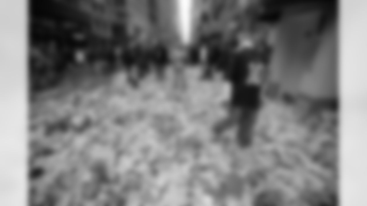 New York Giants fan Ryan Schnepf, 23, walks through the confetti strewn on Broadway after the Super Bowl parade Tuesday, Feb. 5, 2008 in New York. (AP Photo/Gary He)