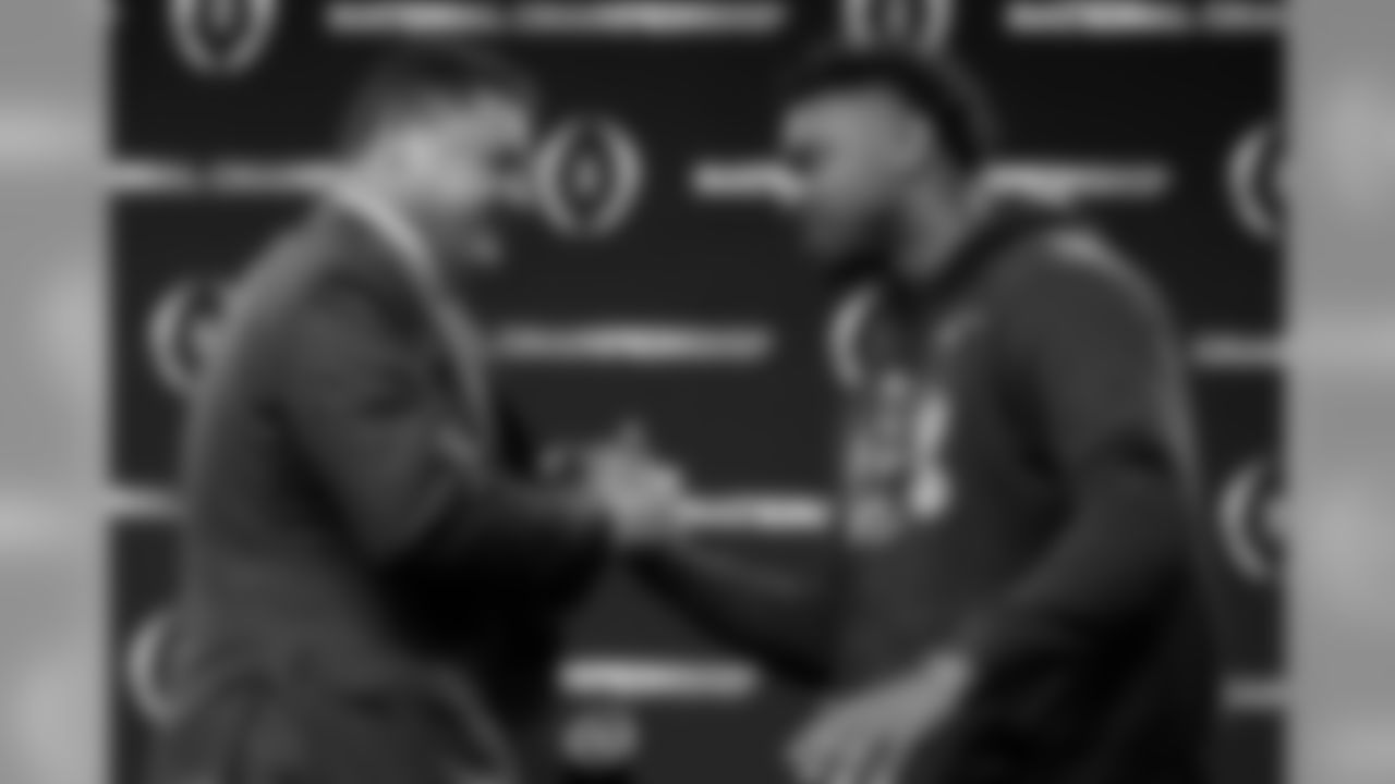 LSU head coach Ed Orgeron, left, greets linebacker Patrick Queen after a news conference for the NCAA College Football Playoff national championship game Tuesday, Jan. 14, 2020, in New Orleans. LSU won 42-25 over Clemson on Monday. (AP Photo/David J. Phillip)