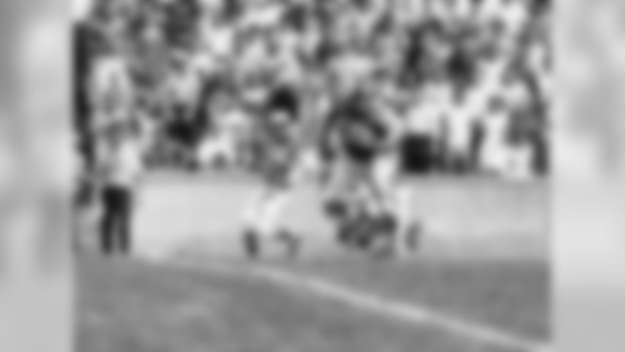 Bob Tucker (38), New York Giants tight end leaves Philadelphia Eagles defenders strewn behind him as he goes for touchdown on pass from quarterback Fran Tarkenton. This occurred at end of first period of Saturday's Giants- Eagles pre-season pro-football game in Princeton University's Palmer Stadium on Sept. 5, 1970. Eagles identifiable by number are Bo Burries (17) right safety, backs Ray Jones (21) and Jim Raye (30). Giants won, 27-7. (AP Photo)