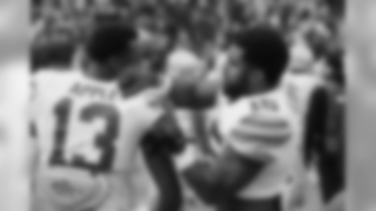 Ohio State running back Ezekiel Elliott (15) adjusts cornerback Eli Apple's shoulder pads before the first half of an NCAA college football game against Michigan, Saturday, Nov. 28, 2015, in Ann Arbor, Mich. (AP Photo/Carlos Osorio)