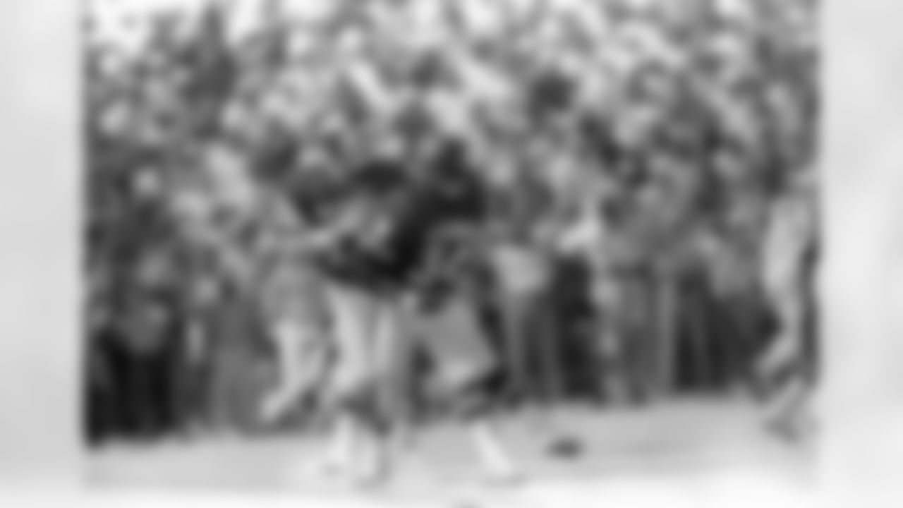 File-This 1986, file photo shows New York Giants quarterback Phil Simms (11) dropping back to pass while the Chicago Bears running back Walter Payton (34) gets set to block him during Pro Bowl Games in Hawaii. (AP Photo/File)