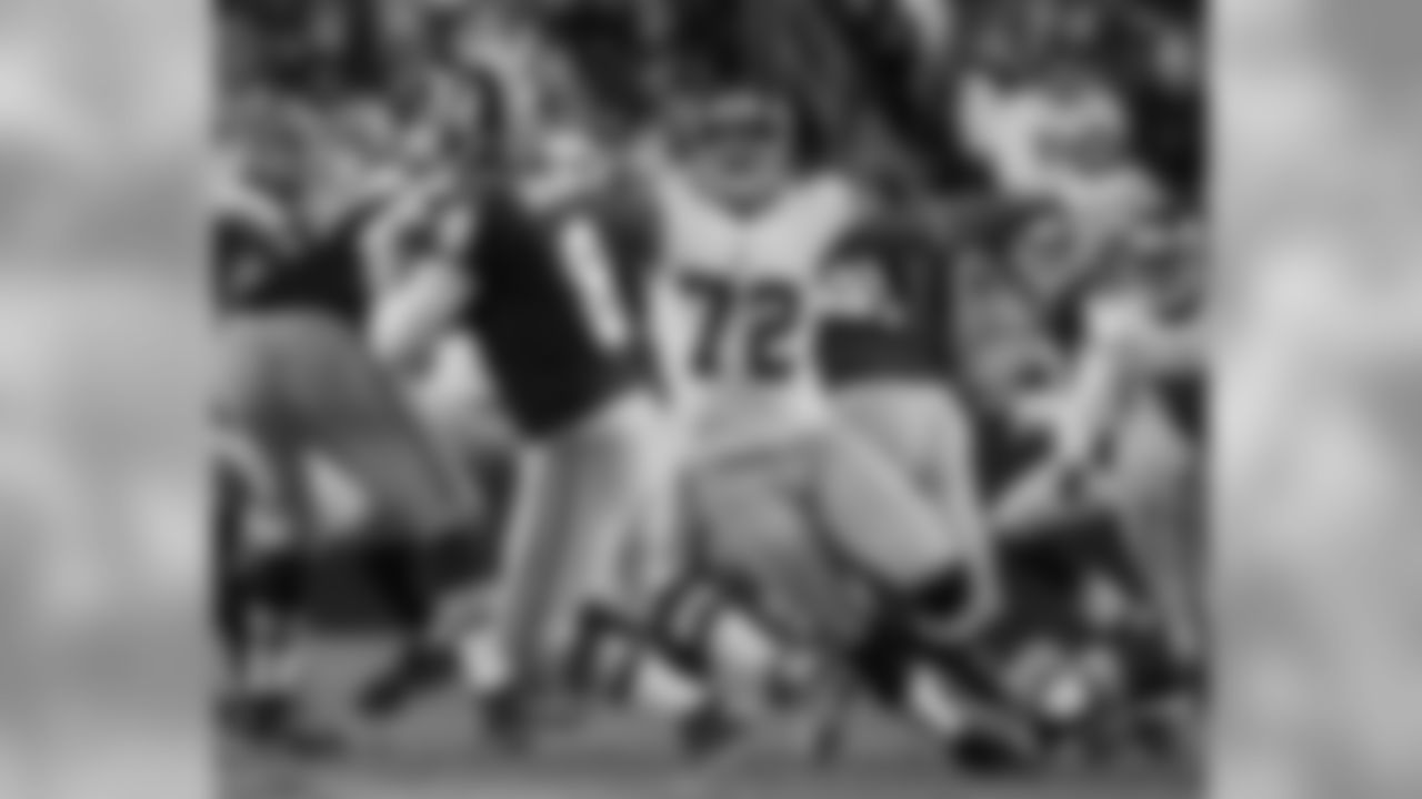 DE Osi Umenyiora puts pressure on Redskins QB Rex Grossman resulting in a sack and fumble.