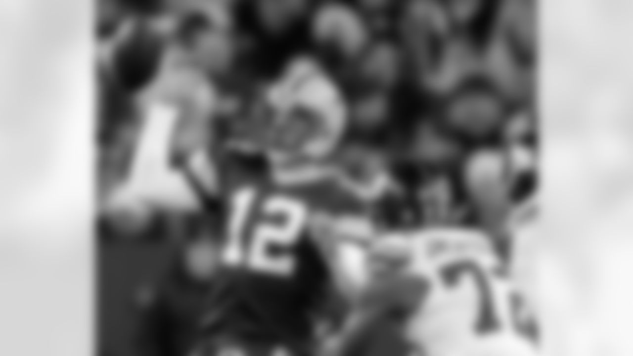 DE Osi Umenyiora puts pressure on QB Aaron Rodgers causing him to fumble the ball.