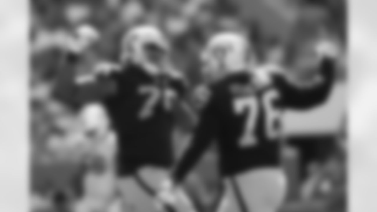 Oakland Raiders offensive tackle Kelechi Osemele (70) celebrates with offensive guard Jon Feliciano (76) during a week 3 NFL football game against the Miami Dolphins on Sunday, Sept. 23, 2018 in Miami Gardens, Fla. Miami won 28-20. (Aaron M. Sprecher via AP)