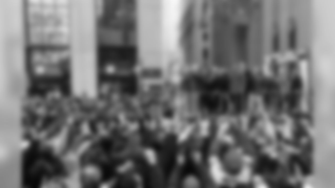 New York Giants fans wave and take photos as the float carrying Eli Manning, center wearing gray jacket, makes it's way up Broadway during the team's NFL football Super Bowl parade in New York, Tuesday, Feb. 7, 2012. The Giants returned from their Super Bowl win to a celebration the likes that only New York can throw: a ticker-tape parade in the Canyon of Heroes on Broadway, where the city has honored stars for almost a century.(AP Photo/Mary Altaffer)
