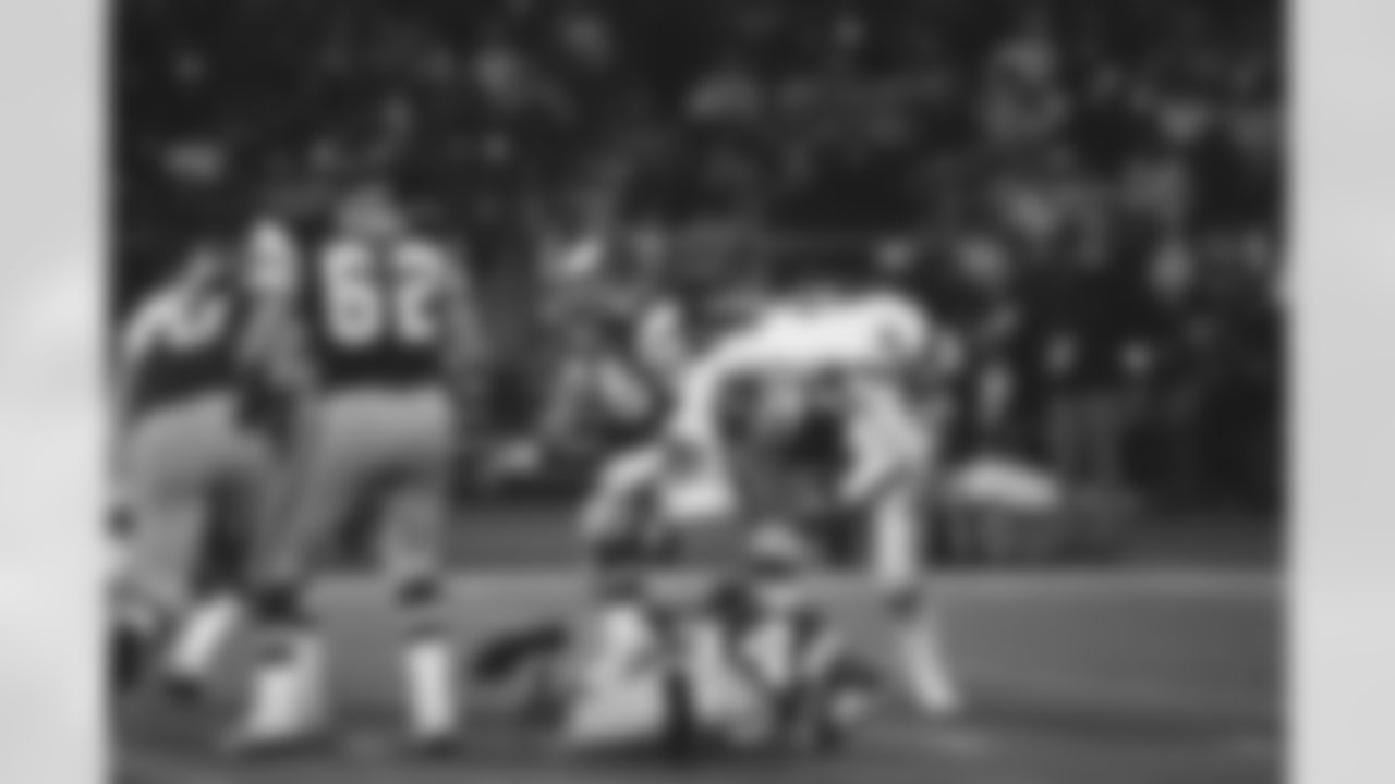 New York Giants Dee Hardison takes a ride on the back of Eagles quarterback Ron Jaworski in wild card playoff game, Dec. 28, 1981, Philadelphia, Pa. Jaworski had a tough day as New Yorks defense limited Jaworski to less than 50 percent of pass completions and sacked him three times. Eagles lost, 27-21. Eagles Hubert Oliver (34), Pete Perot (62) and Jerry Sisemore (76) are also shown. (AP Photo)
