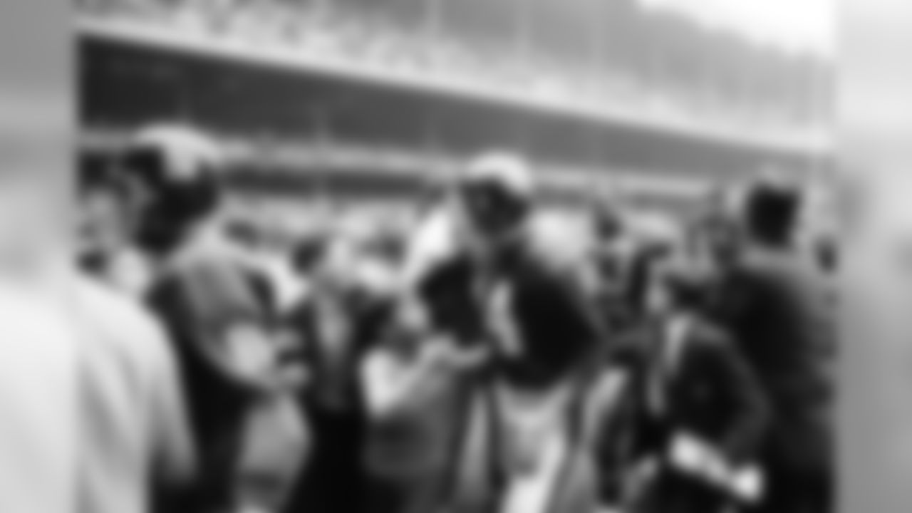 Y.A. Tittle the hero is used to receiving attention and adulation wherever he goes. Here admiring young fans escort him from the field after a victory over the Dallas Cowboys, Nov. 12, 1963. (AP Photo/Ruben Goldberg)