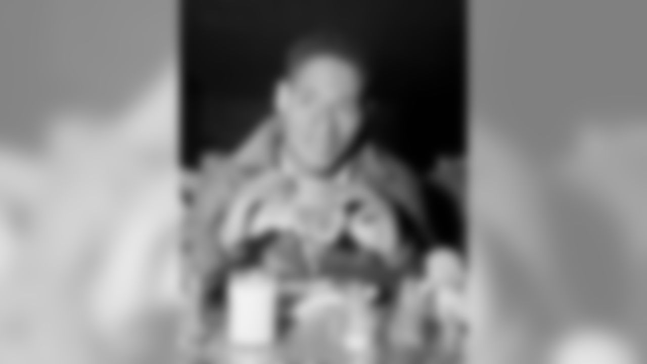 Emlen Tunnell, star halfback of the the Hawkeyes at Iowa City, grins despite a cracked lip as he tries to eat an enormous ham sandwich at a dinner following the game with Purdue in Iowa City, Iowa, Sept. 28, 1946. Tunnell scored both of Iowa's touchdowns when the Hawkeyes downed Purdue, 16-0. (AP Photo/Charles Knoblock)