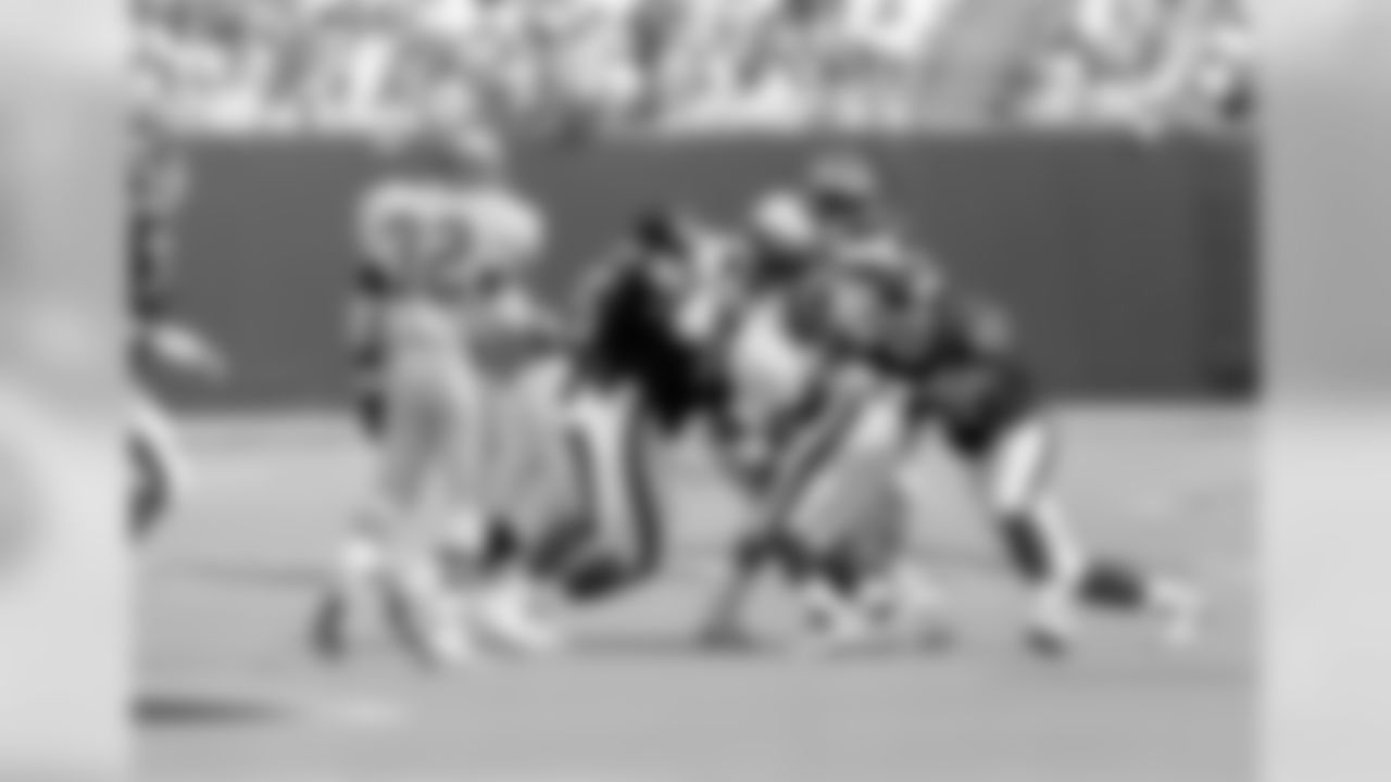 Philadelphia Eagles' running back Herschel Walker, center, is stopped by New York Giants linebacker Corey Miller (57), safety Jarvis Williams (26), linebacker Michael Brooks (94) and linebacker Carlton Bailey in the third quarter at Giants Stadium, East Rutherford, N.J., Sept. 4, 1994. (AP Photo/Adam Nadel)